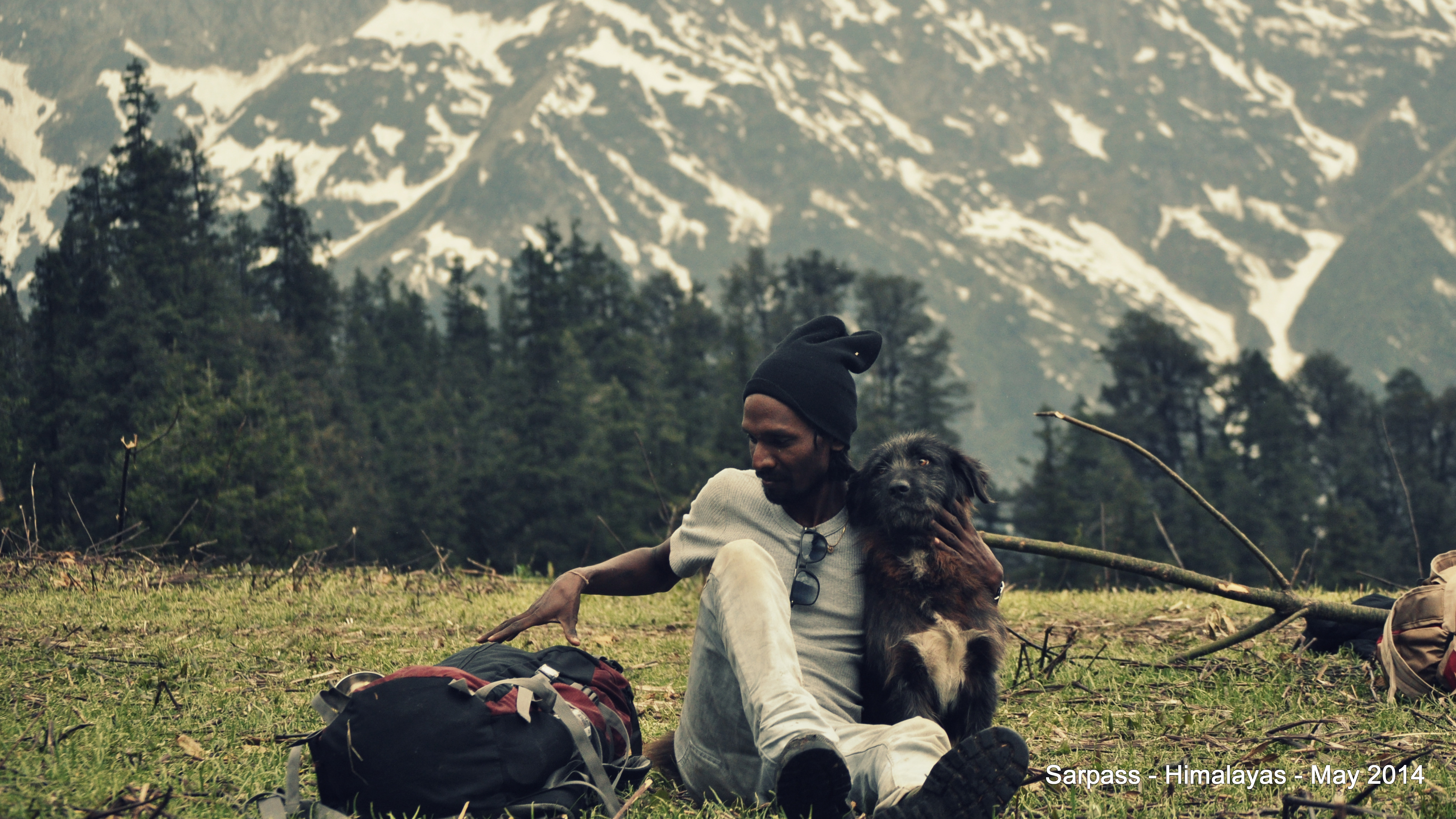 Balaji with backpack and dog in the mountains